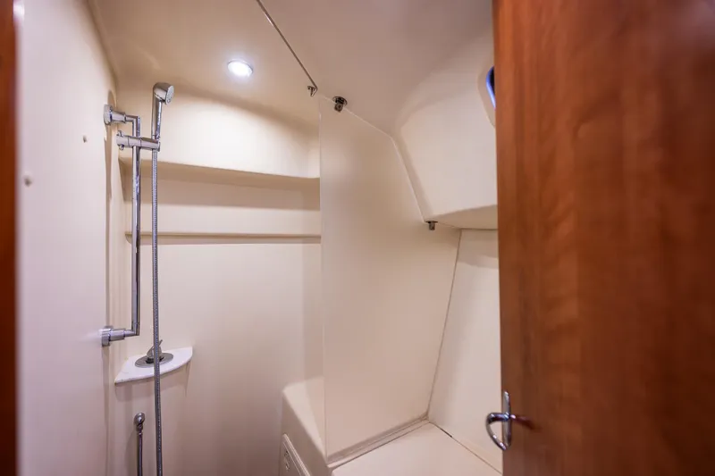  Yacht Photos Pics 2015 Marlow-Hunter 31 yacht bathroom with shower and wooden door.