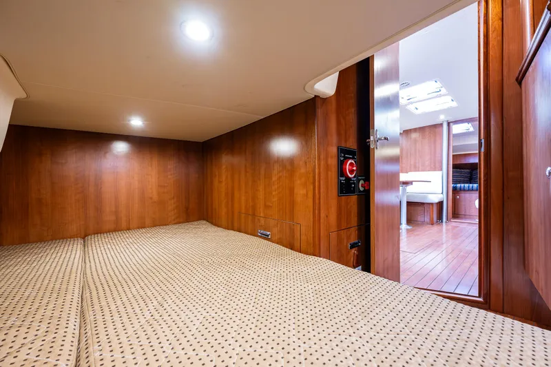  Yacht Photos Pics 2015 Marlow-Hunter 31 yacht interior cabin with wooden finish and cozy bedding.
