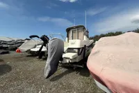 2019 Quicksilver 555 Pilothouse boat in storage, covered and parked outdoors.