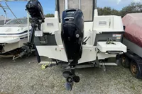 2019 Quicksilver 555 Pilothouse boat with dual outboard motors on a trailer.