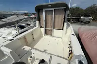 2019 Quicksilver 555 Pilothouse boat with spacious deck and sliding cabin door.