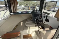 Interior of 2019 Quicksilver 555 Pilothouse boat with steering wheel and dashboard.
