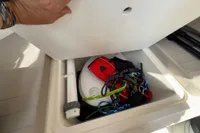Storage compartment in 2019 Quicksilver 555 Pilothouse boat with safety gear and ropes.