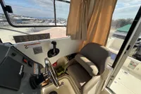 Interior of 2019 Quicksilver 555 Pilothouse boat with steering wheel and seat.