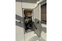 Open storage compartment on 2019 Quicksilver 555 Pilothouse boat, containing various boating items.
