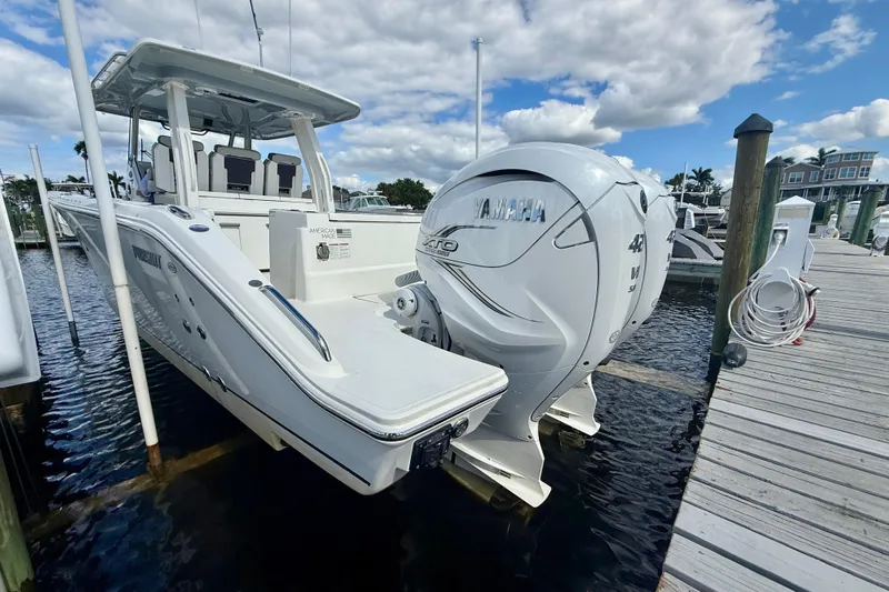  Yacht Photos Pics 2023 Pursuit S 358 Sport boat docked, featuring Yamaha outboard engines under a partly cloudy sky.