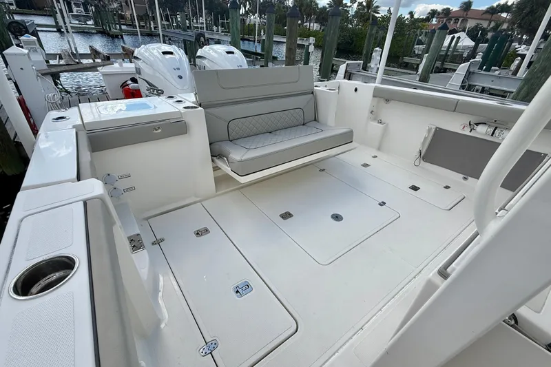  Yacht Photos Pics 2023 Pursuit S 358 Sport boat interior with seating and storage compartments.