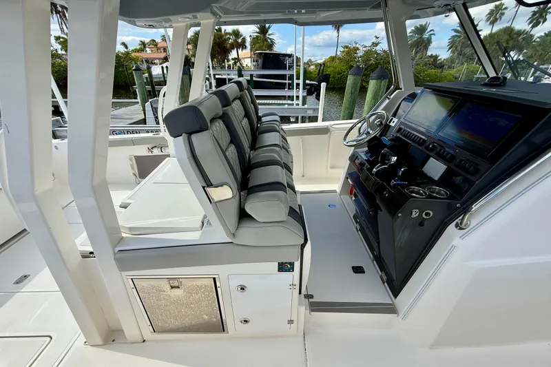  Yacht Photos Pics 2023 Pursuit S 358 Sport boat interior with modern helm and seating.