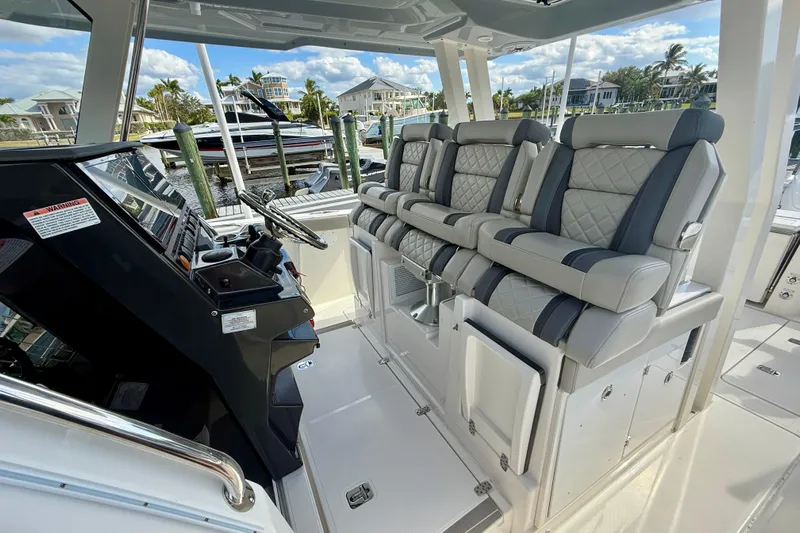  Yacht Photos Pics 2023 Pursuit S 358 Sport boat interior with luxurious seating and modern helm controls.