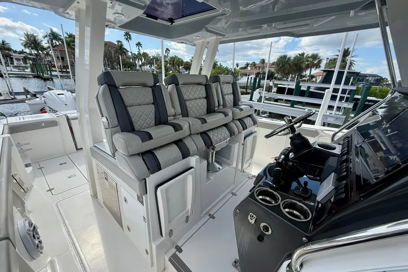  Yacht Photos Pics 2023 Pursuit S 358 Sport boat interior with luxurious seating and modern dashboard.