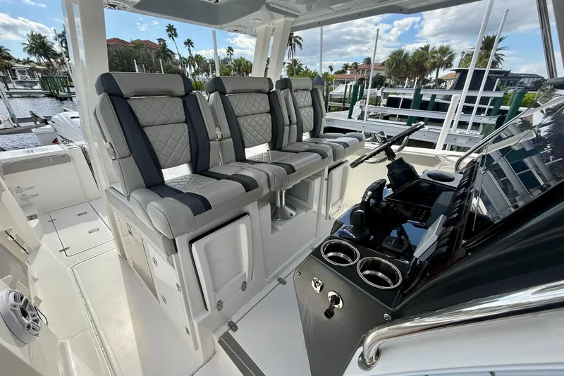  Yacht Photos Pics 2023 Pursuit S 358 Sport boat interior with luxury seating and modern helm controls.