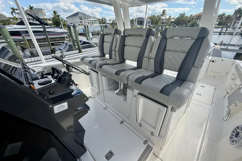  Yacht Photos Pics 2023 Pursuit S 358 Sport boat interior with luxury seating and modern dashboard.