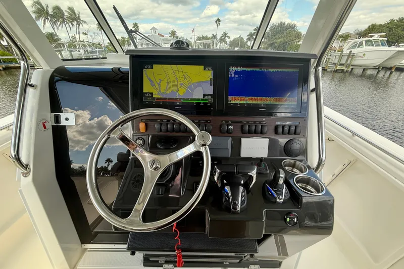  Yacht Photos Pics 2023 Pursuit S 358 Sport boat dashboard with navigation screens and controls.