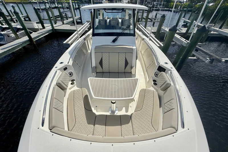  Yacht Photos Pics 2023 Pursuit S 358 Sport boat with spacious seating at a marina dock.