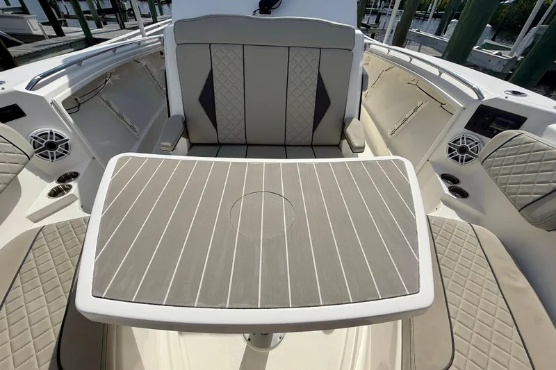  Yacht Photos Pics 2023 Pursuit S 358 Sport boat interior with cushioned seating and table.