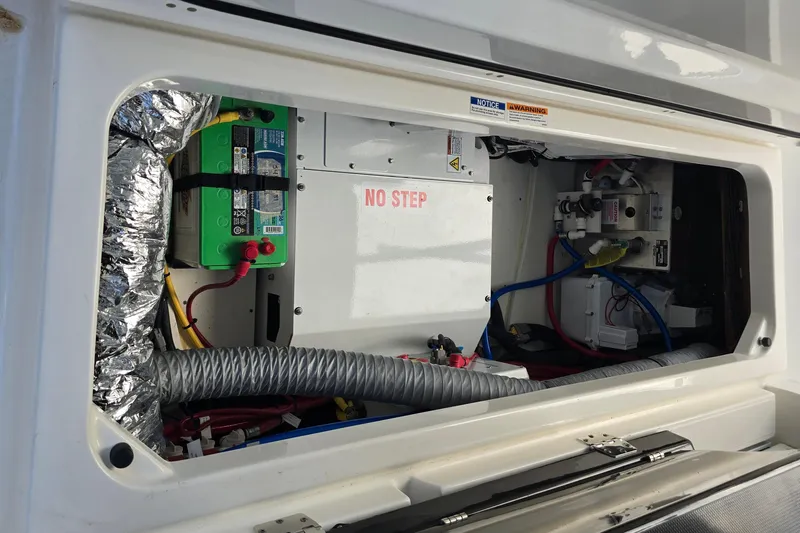  Yacht Photos Pics 2023 Pursuit S 358 Sport boat electrical compartment with wiring and battery setup.