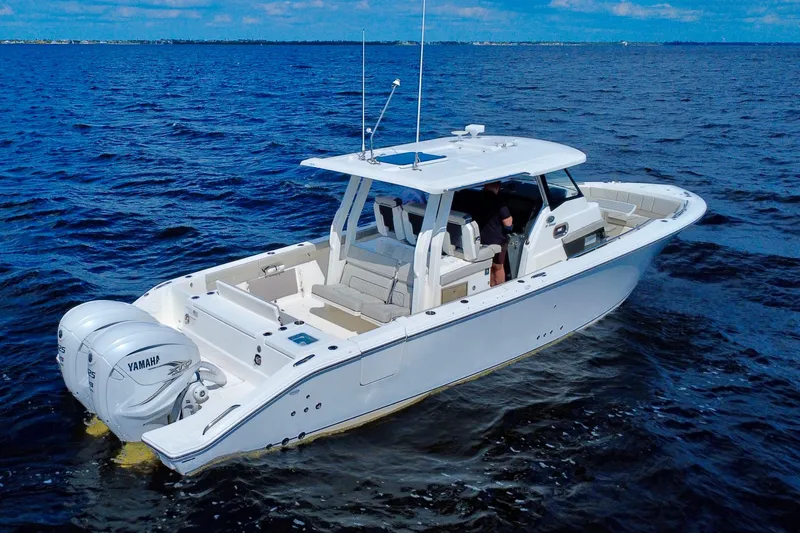  Yacht Photos Pics 2023 Pursuit S 358 Sport boat cruising on open water with twin Yamaha engines.