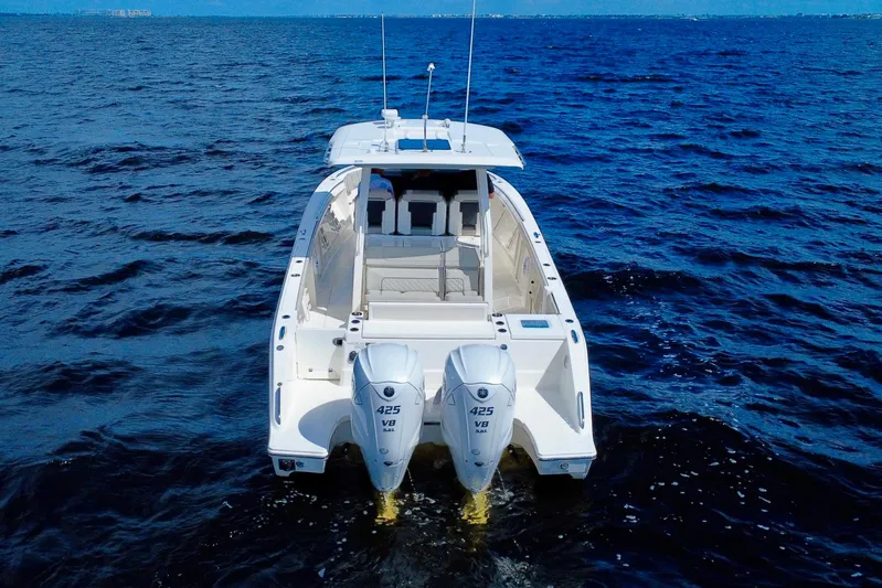  Yacht Photos Pics 2023 Pursuit S 358 Sport boat on open water, rear view with dual engines.