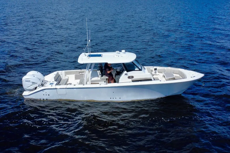  Yacht Photos Pics 2023 Pursuit S 358 Sport boat cruising on open water.