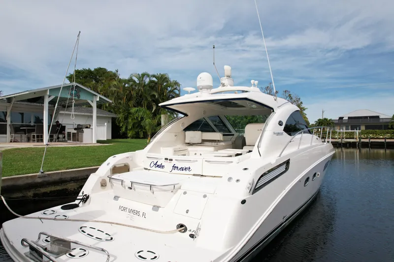 Anke Forever Yacht Photos Pics 2010 Sea Ray 470 Sundancer yacht docked by a waterfront home.