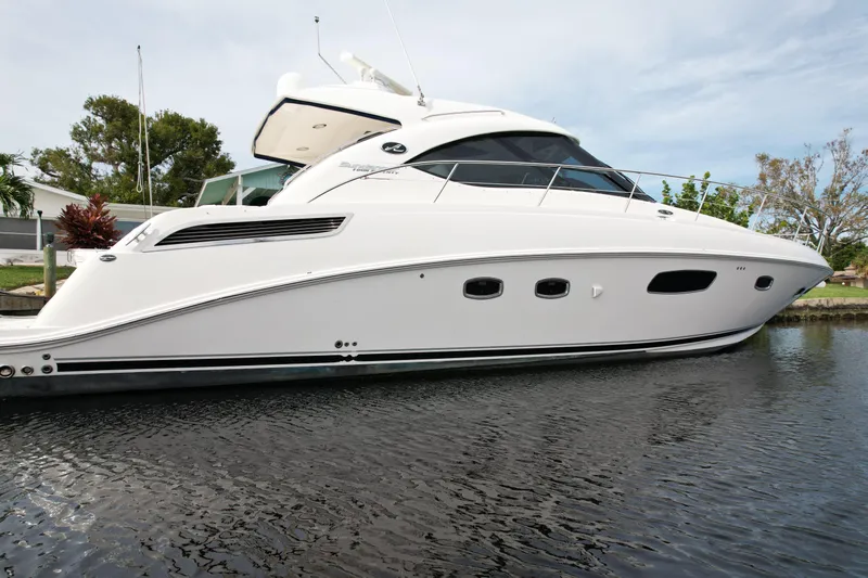 Anke Forever Yacht Photos Pics 2010 Sea Ray 470 Sundancer yacht on calm water, side view.