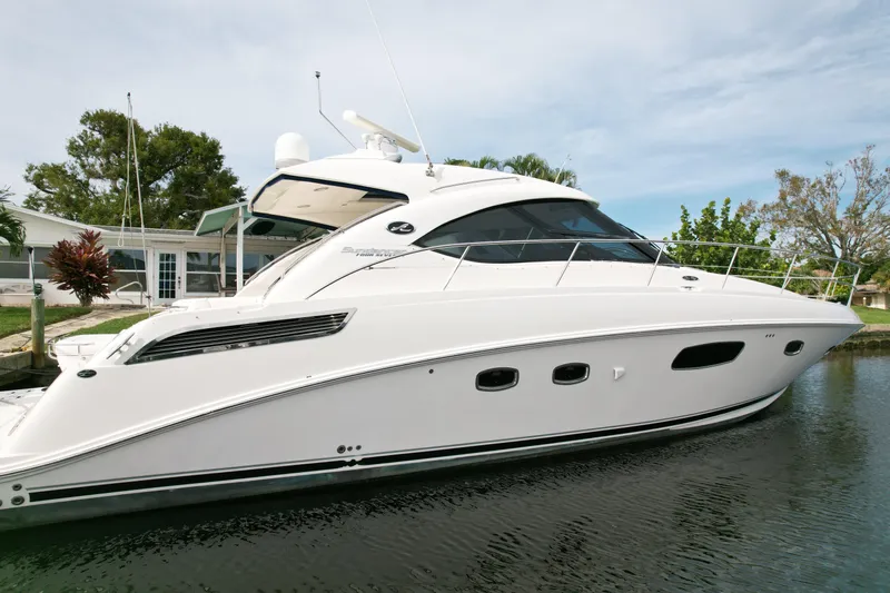 Anke Forever Yacht Photos Pics 2010 Sea Ray 470 Sundancer yacht docked in a serene marina setting.