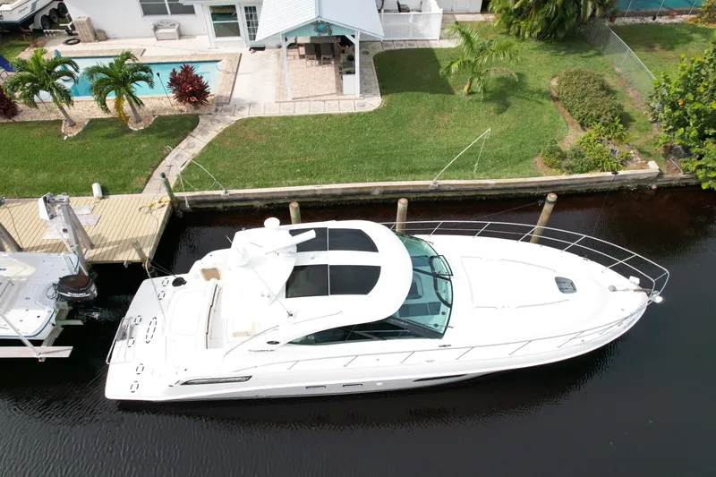 Anke Forever Yacht Photos Pics 2010 Sea Ray 470 Sundancer yacht docked by a waterfront home with pool.