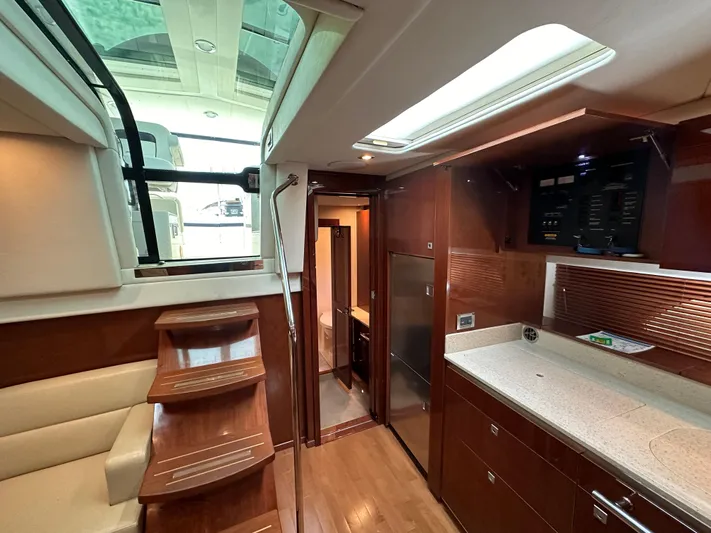 Anke Forever Yacht Photos Pics Luxurious interior of 2010 Sea Ray 470 Sundancer yacht with modern kitchen and seating area.