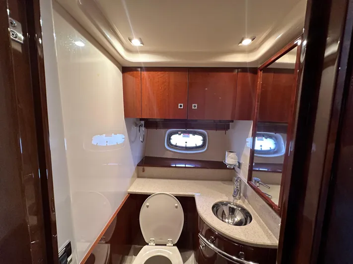 Anke Forever Yacht Photos Pics Luxurious bathroom in 2010 Sea Ray 470 Sundancer yacht with wood cabinetry and modern fixtures.
