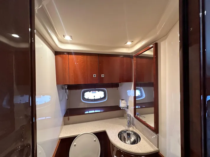 Anke Forever Yacht Photos Pics Luxurious bathroom in 2010 Sea Ray 470 Sundancer yacht with modern fixtures and wood cabinetry.