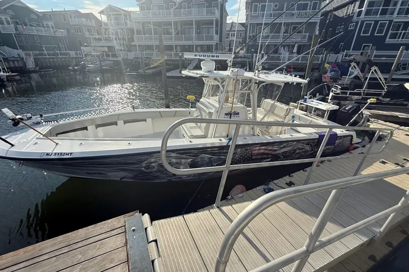  Yacht Photos Pics 2006 SeaVee 340B boat docked at marina with fishing rods and American flag design.