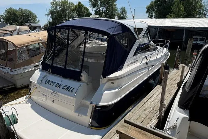 Knot On Call Yacht Photos Pics 2007 Regal Commodore 4060 yacht docked, featuring a blue canopy and "Knot on Call" name.