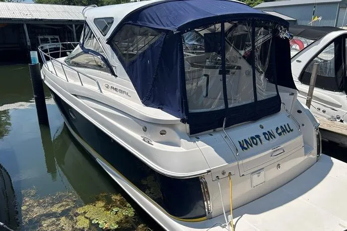 Knot On Call Yacht Photos Pics 2007 Regal Commodore 4060 boat docked, featuring blue canopy and "Knot on Call" name.