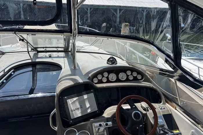 Knot On Call Yacht Photos Pics 2007 Regal Commodore 4060 yacht cockpit with Garmin navigation system and steering wheel.