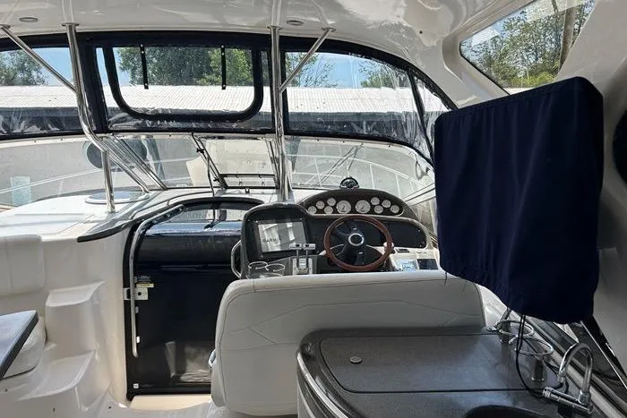 Knot On Call Yacht Photos Pics Interior view of 2007 Regal Commodore 4060 yacht cockpit with steering wheel and navigation instruments.