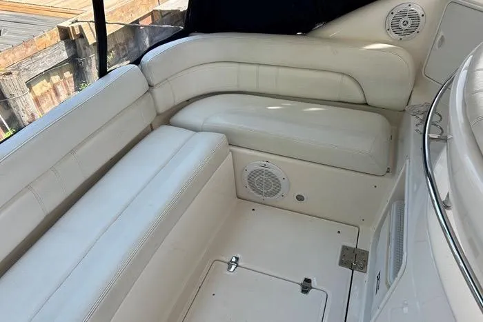 Knot On Call Yacht Photos Pics 2007 Regal Commodore 4060 boat interior with white leather seating and built-in speakers.