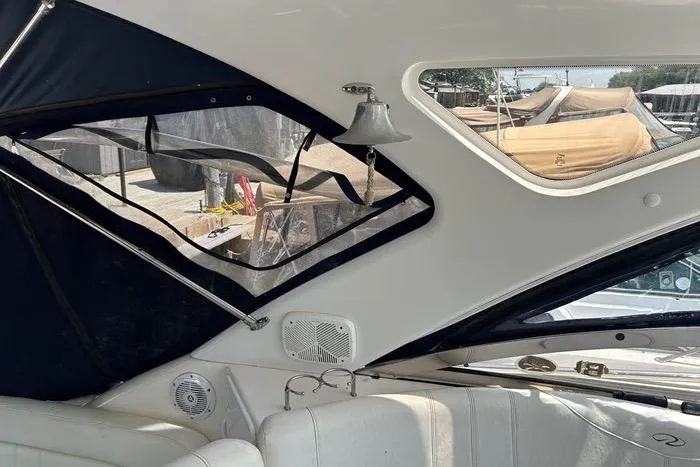 Knot On Call Yacht Photos Pics Interior view of 2007 Regal Commodore 4060 yacht with white seating and windows.