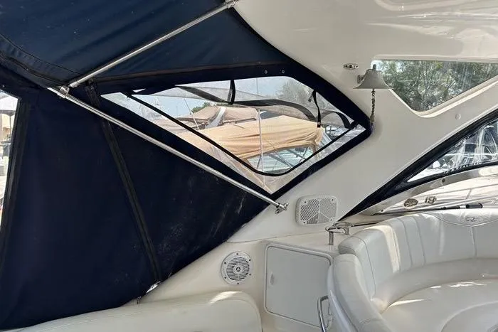 Knot On Call Yacht Photos Pics 2007 Regal Commodore 4060 interior with white seating and blue canopy.