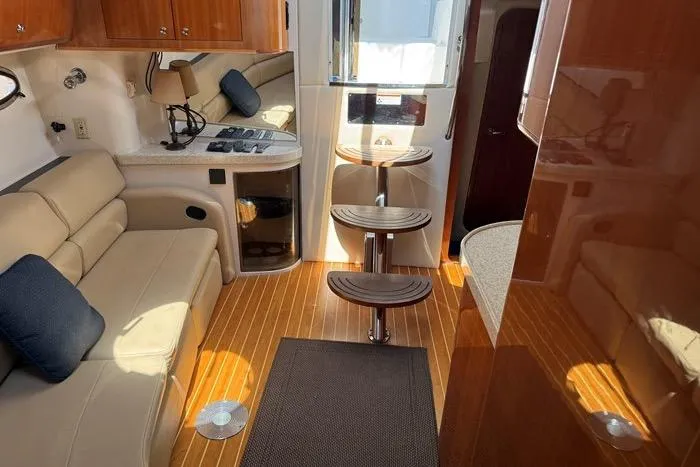 Knot On Call Yacht Photos Pics Interior of 2007 Regal Commodore 4060 yacht with wooden flooring and beige seating.