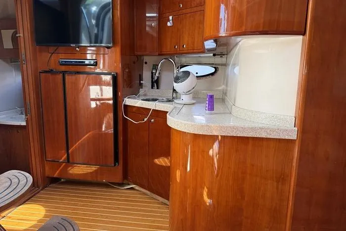 Knot On Call Yacht Photos Pics 2007 Regal Commodore 4060 yacht interior with wooden cabinetry and modern amenities.