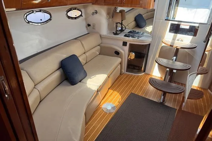 Knot On Call Yacht Photos Pics Interior of 2007 Regal Commodore 4060 yacht with beige seating and wooden flooring.