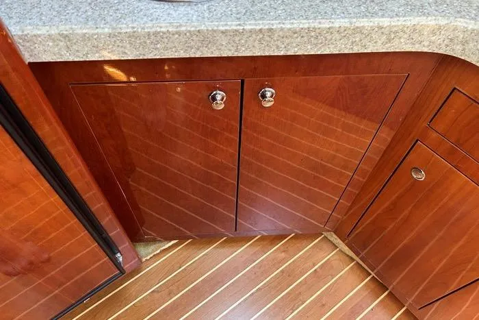Knot On Call Yacht Photos Pics Wooden cabinetry and flooring in a 2007 Regal Commodore 4060 yacht interior.