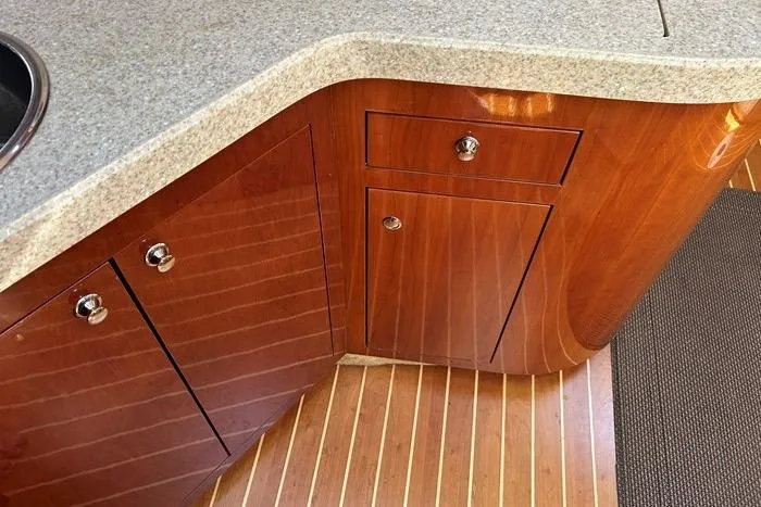 Knot On Call Yacht Photos Pics 2007 Regal Commodore 4060 yacht interior with polished wood cabinets and granite countertop.