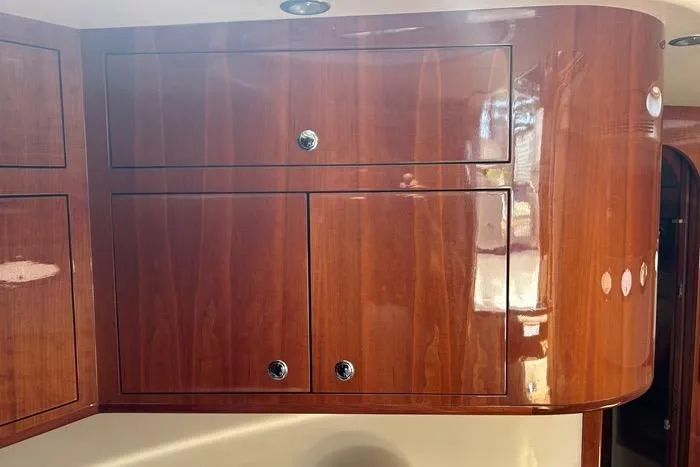 Knot On Call Yacht Photos Pics Wooden cabinetry inside a 2007 Regal Commodore 4060 yacht, featuring polished finish and chrome handles.