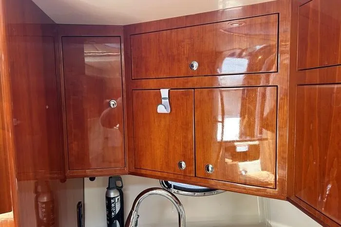 Knot On Call Yacht Photos Pics Wooden cabinets in a 2007 Regal Commodore 4060 yacht interior, featuring polished finish and modern fixtures.