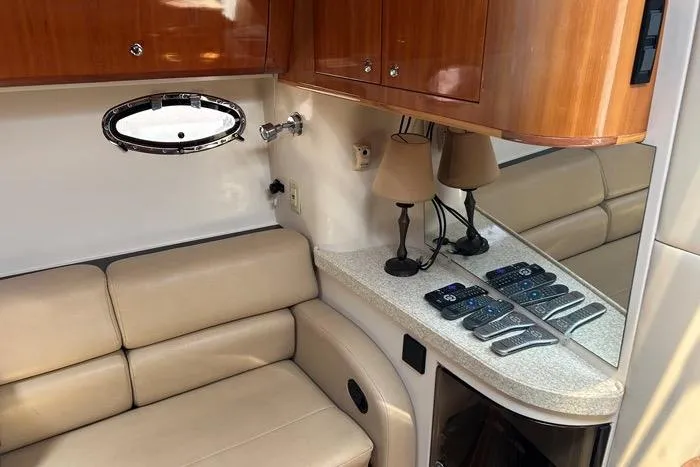 Knot On Call Yacht Photos Pics Interior of 2007 Regal Commodore 4060 yacht with beige seating and wooden cabinetry.