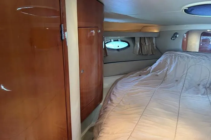 Knot On Call Yacht Photos Pics Luxurious cabin interior of 2007 Regal Commodore 4060 yacht with wood paneling and cozy bed.