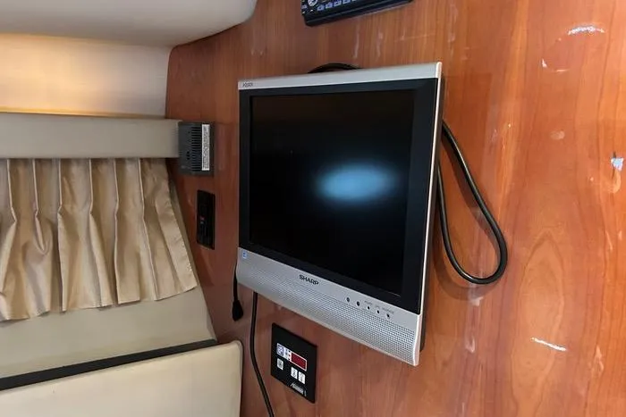 Knot On Call Yacht Photos Pics Flat-screen TV mounted on a 2007 Regal Commodore 4060 yacht's wooden interior wall.