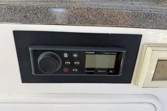 Knot On Call Yacht Photos Pics Fusion MS-RA70NSX stereo system on 2007 Regal Commodore 4060 boat dashboard.