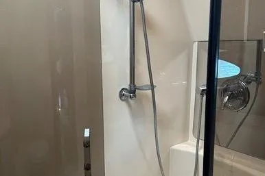 Knot On Call Yacht Photos Pics Shower area in 2007 Regal Commodore 4060 yacht, featuring modern fixtures and glass door.